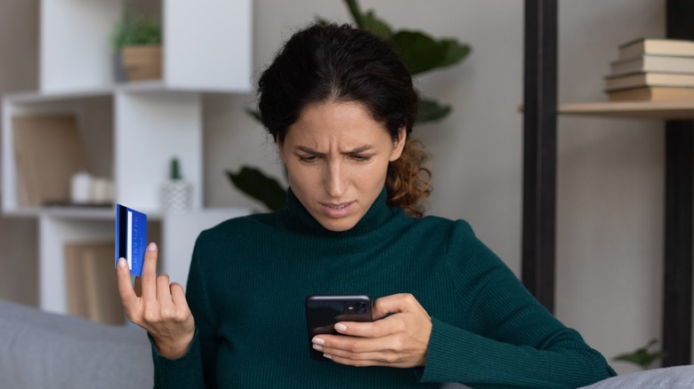 Woman looking a credit card charge