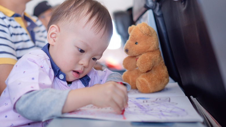 baby coloring on plane