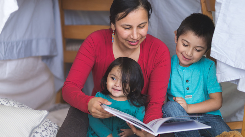 mom reading book to children