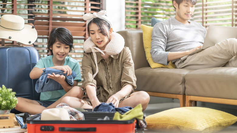 family packing suitcase