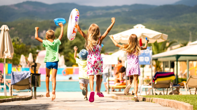 children running toward pool