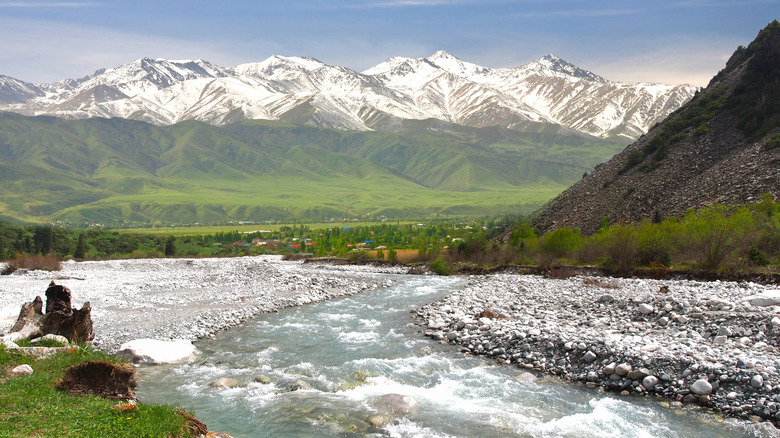 River, green hills, and mountains