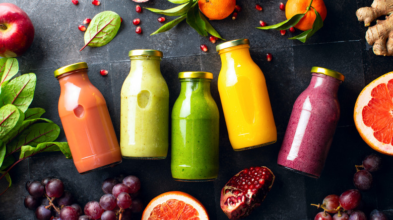 Bottled smoothies surrounded by fruit