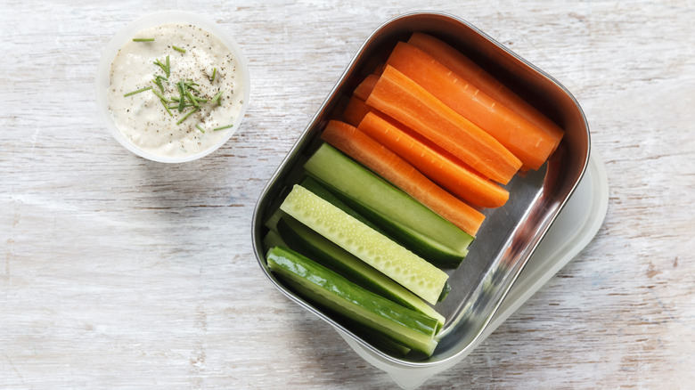 Sliced cucumber and carrots with dip