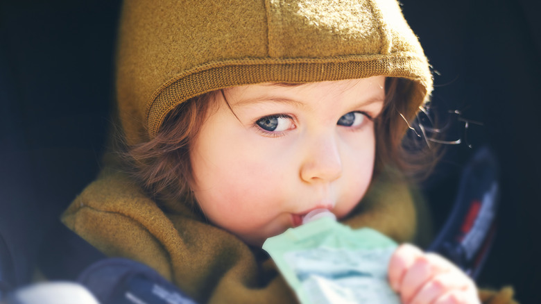 Toddler eating puree from pouch