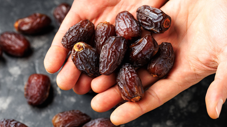 Hands holding Medjool dates