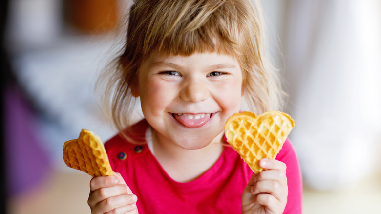 Girl holding heart shaped waffles