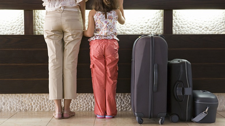 Mother and child checking into hotel