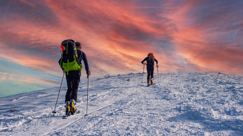 snow mountaineering during pink sunset