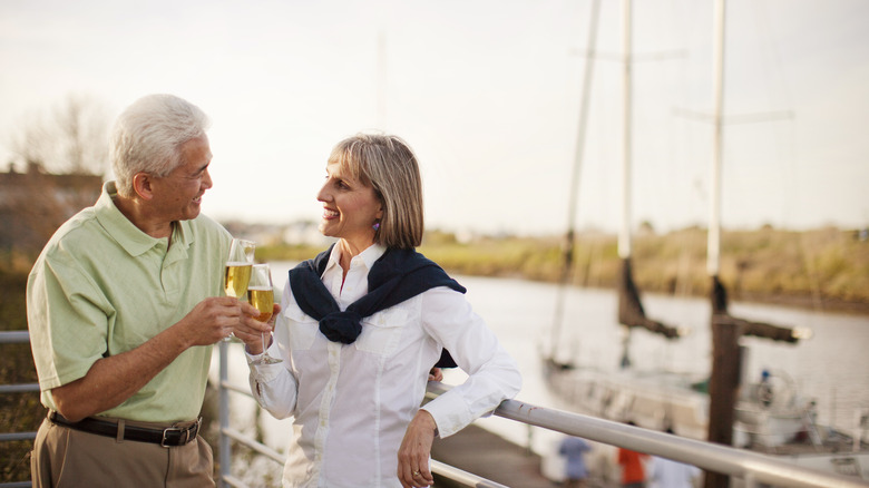 couple drinking champagne in a marina