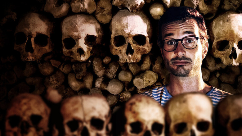 David Farrier stands in an ossuary
