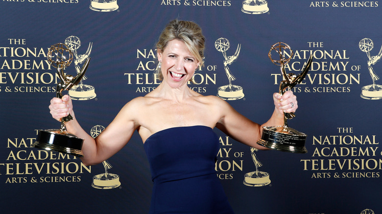 Samantha Brown holding up awards