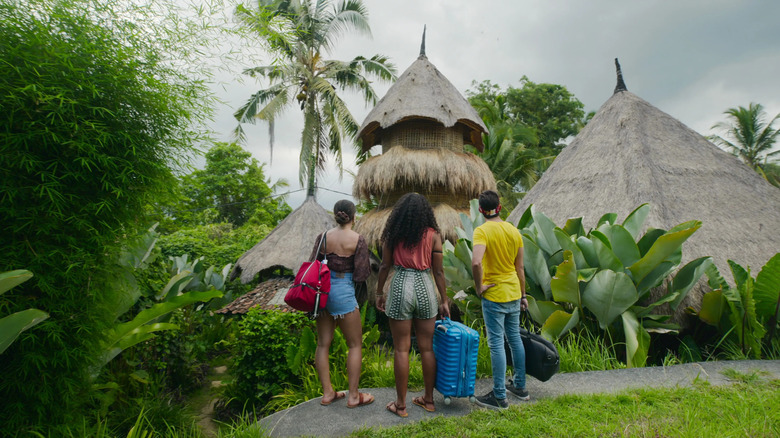 The hosts approach a bungalow