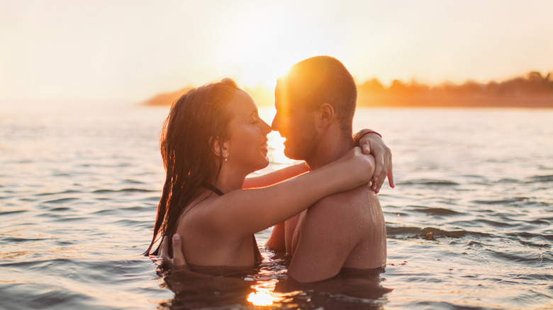 Couple kissing in ocean