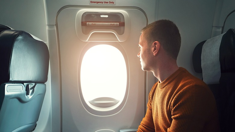man looking at airplane door