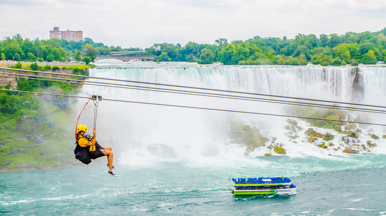 Woman ziplining across waterfall