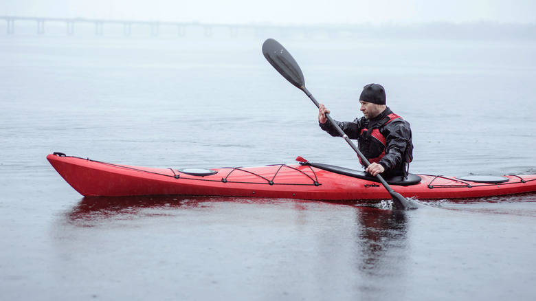 man kayaking in cold weather