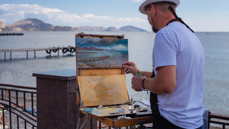 man painting canvas