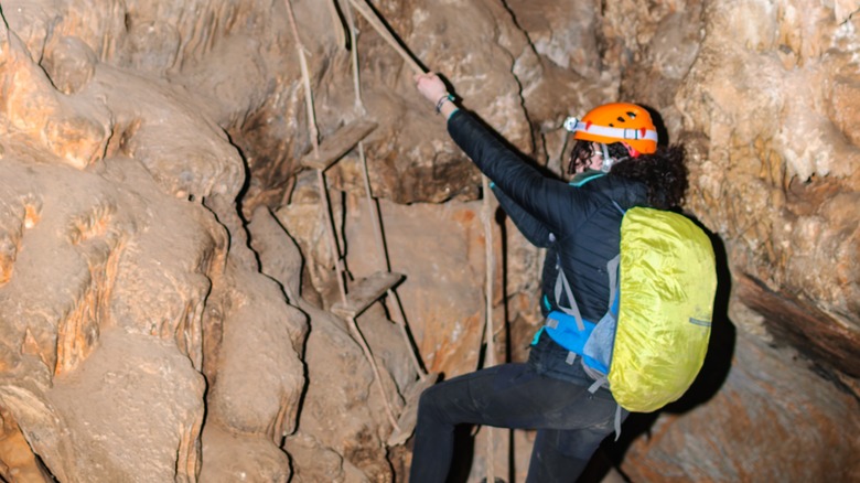 a spelunker using ropes