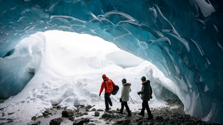 hikers exploring glacial cave