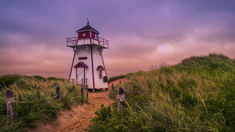 Red and white lighthouse at sunset on Prince Edward Island