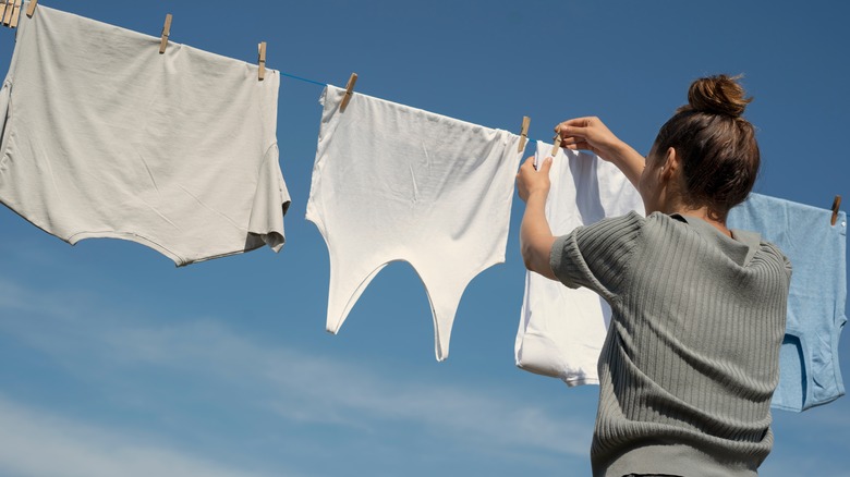 woman hanging clothes outside