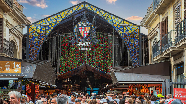 A crowd of people attempts to move at La Boqueria