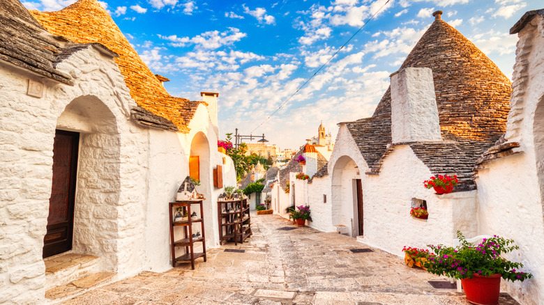 Dome-shaped dwellings on cobblestone street in Puglia