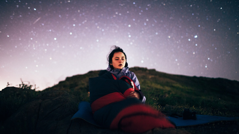 woman camping in sleeping bag