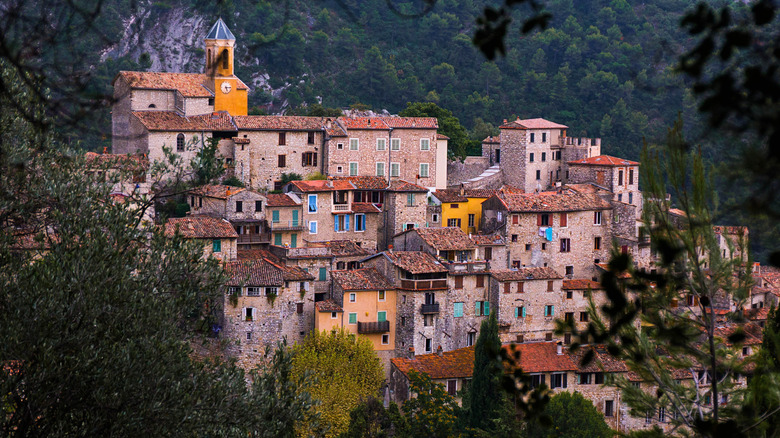 Houses crowd together on the hilltop village of Peillon