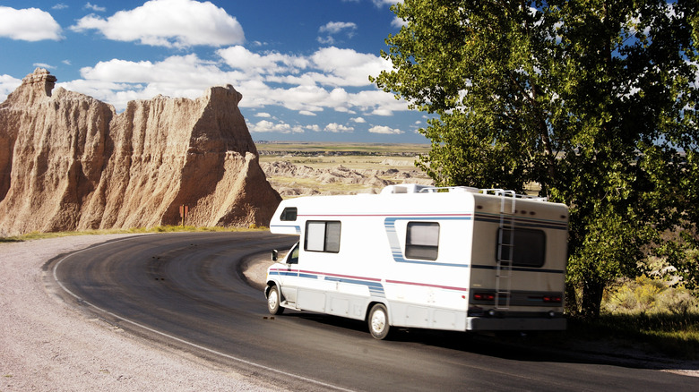 A recreational vehicle drives through Badlands National Park in South Dakota