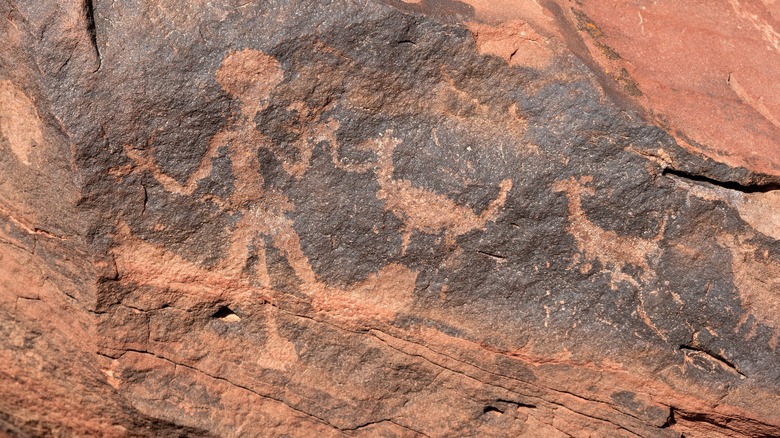 Petroglyphs of person and animals