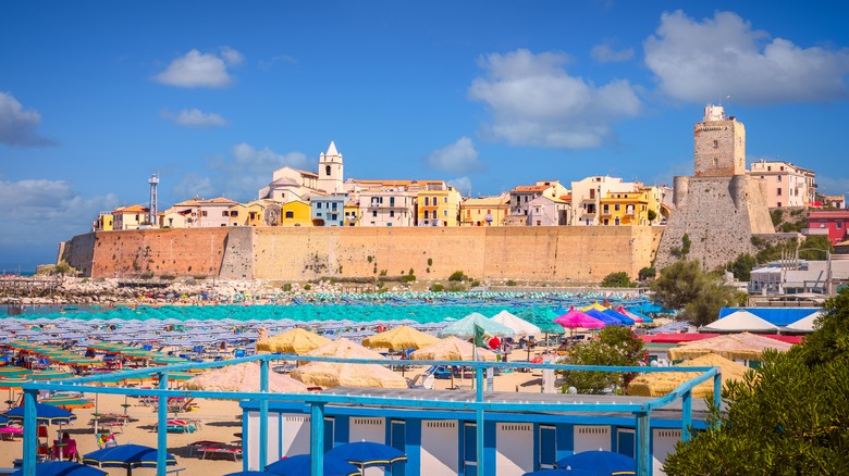 Panoramic view of beach with colorful umbrellas and walled city in Termoli.