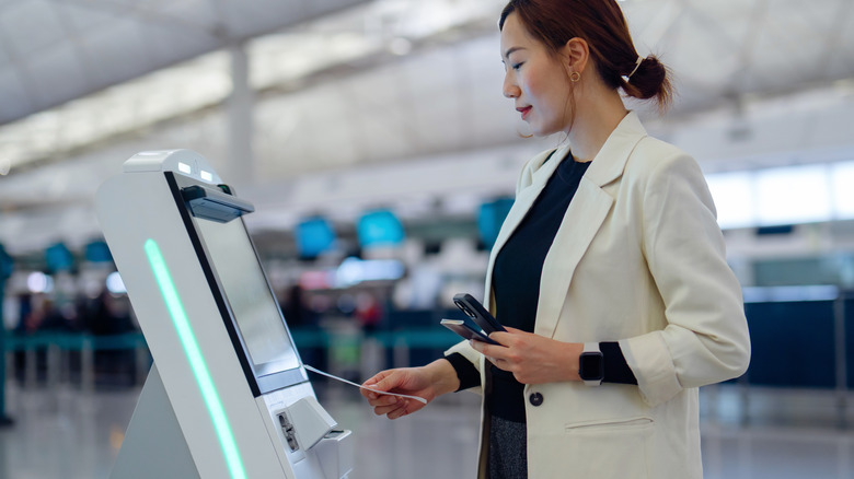 Woman using automated check-in