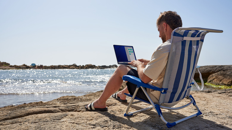 Digital nomad working by the sea