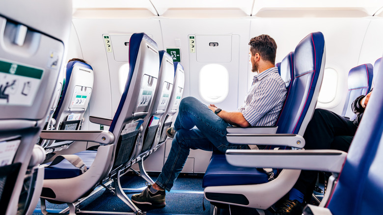 passenger sitting in airplane seat