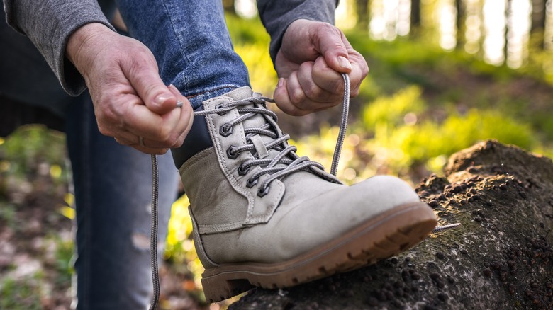 Hiker tying a hiking boot