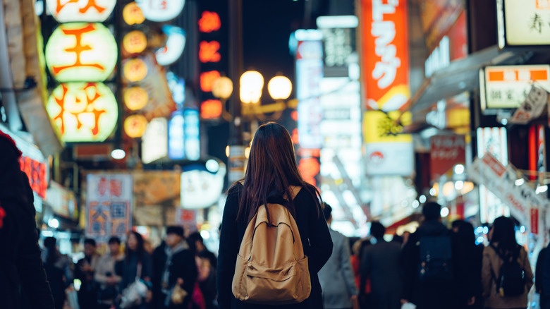 A woman on a crowded street in Japan