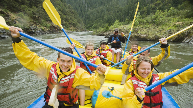 Young people in a whitewater raft on a river