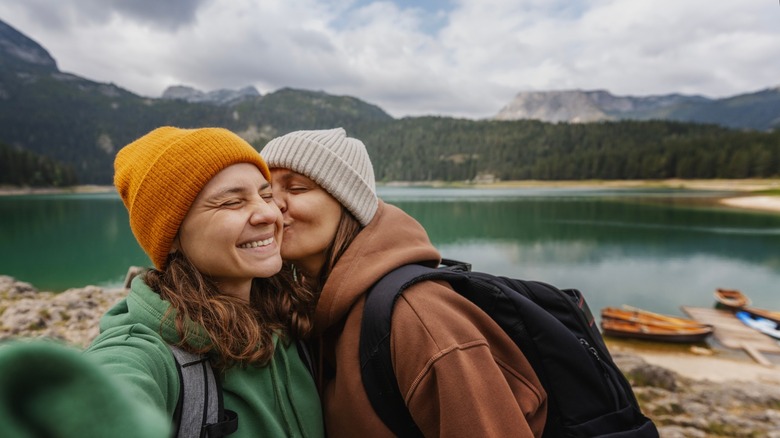 person kissing their partner's cheek