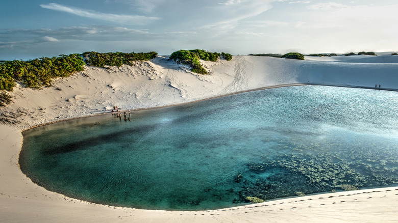 visitors swimming in a lagoon at Lençóis Maranhenses National Park