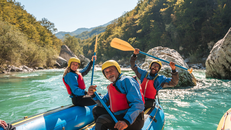 three people on a raft enjoy white water rafting in North Carolina