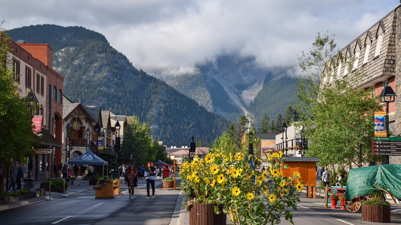 the main street in Banff with mountains in the distance