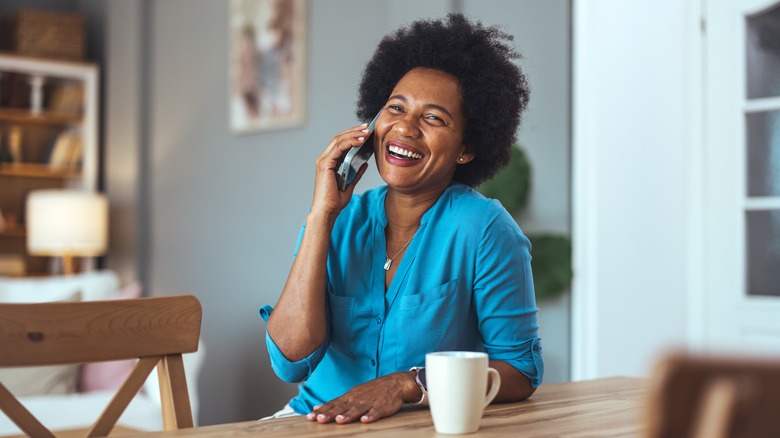 Smiling woman during phone call