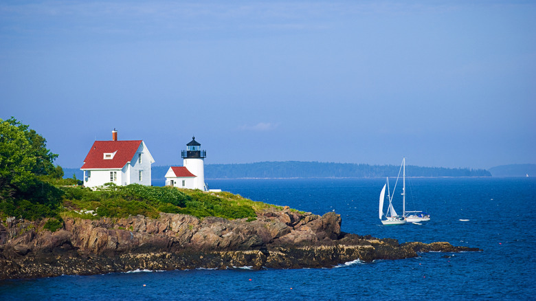 A small lighthouse on a rocky point in Maine