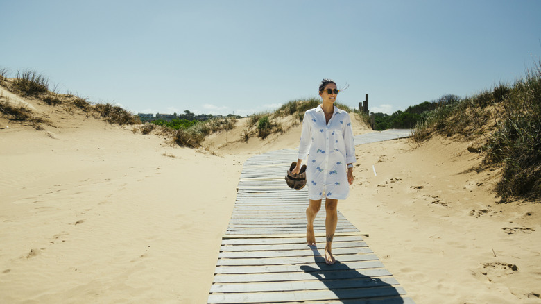 Woman walking on the beach boardwalk in Jose Ignacio