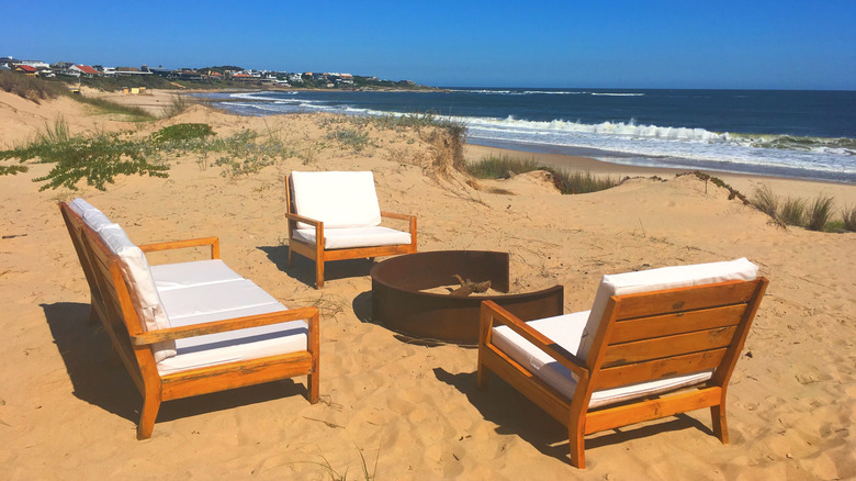 Wooden chairs and fire pit on José Ignacio Beach