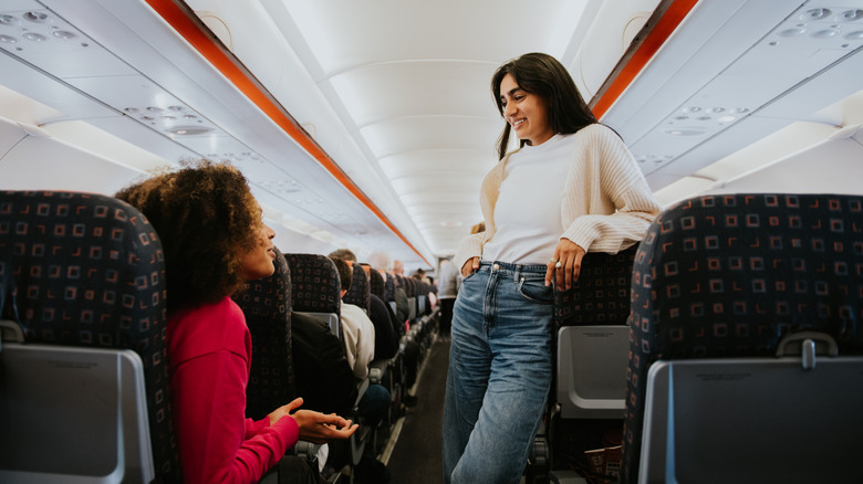 Two airplane passengers chatting