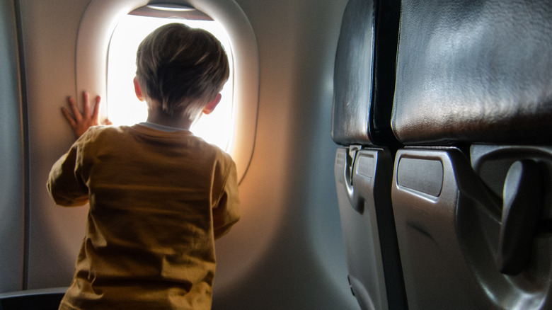 Child looking out plane window