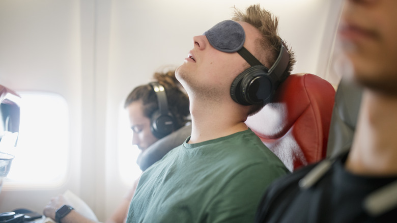 Traveler sleeping on airplane